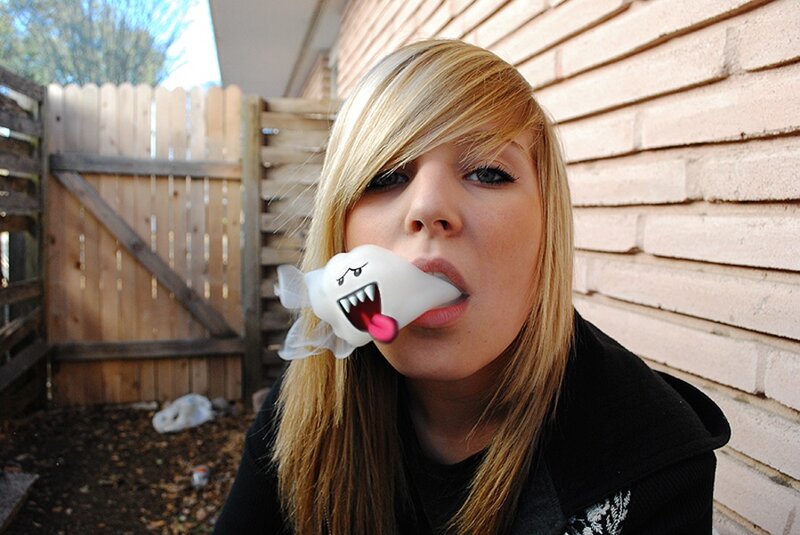 woman with ghost toy in mouth