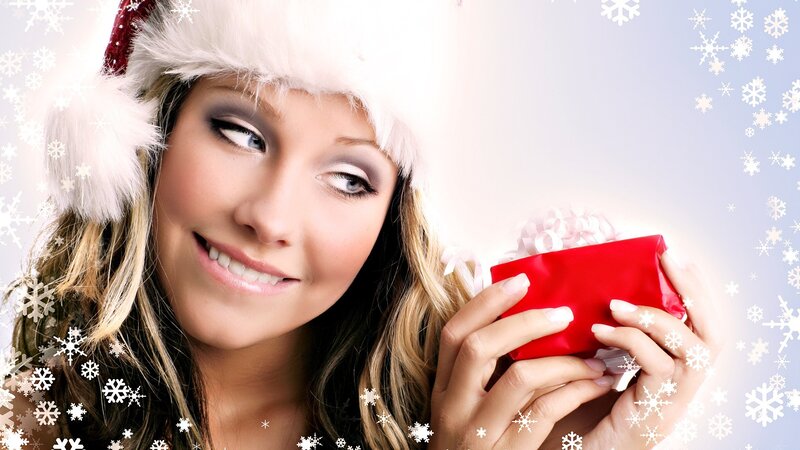 woman with gift and santa hat