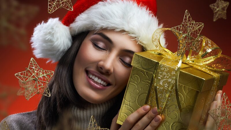 woman with gift and santa hat