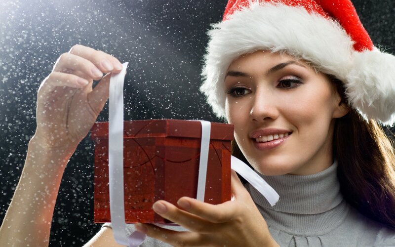 woman with gift box and santa hat