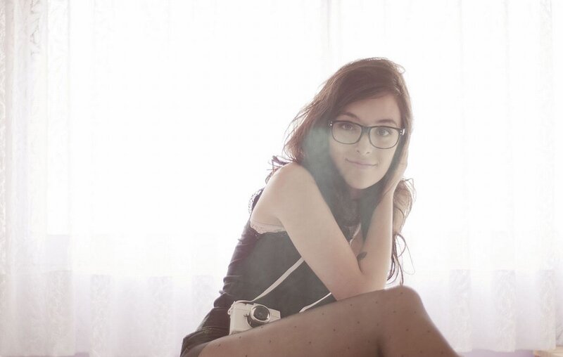 woman with glasses and camera