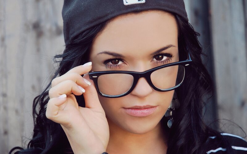 woman with glasses and cap