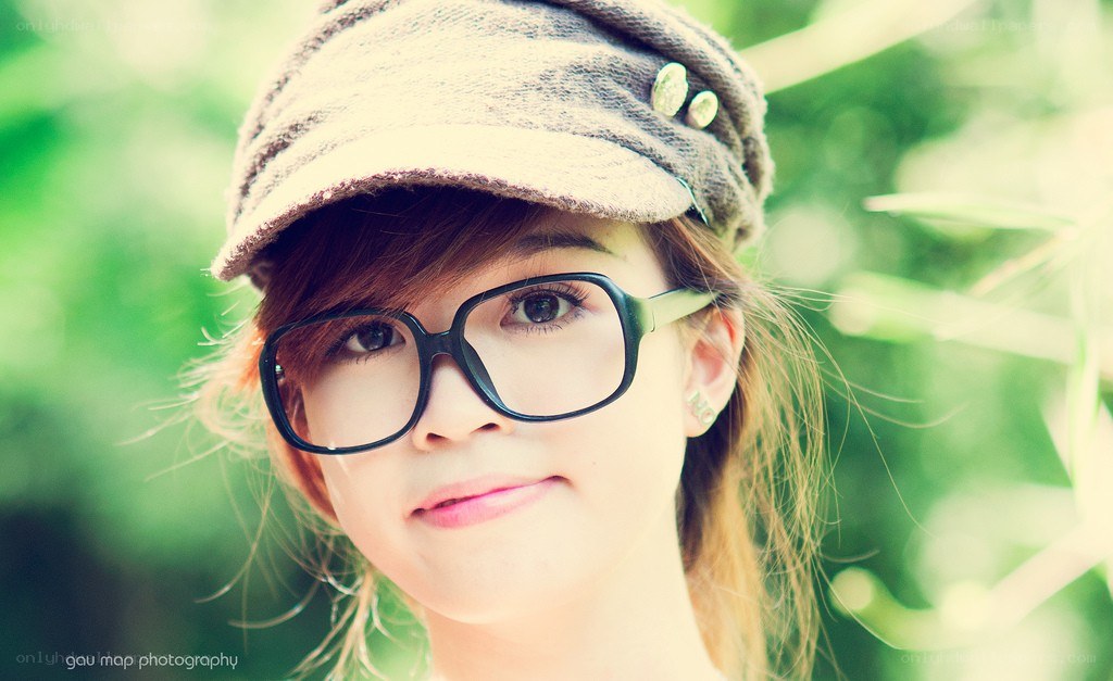woman with glasses and cap
