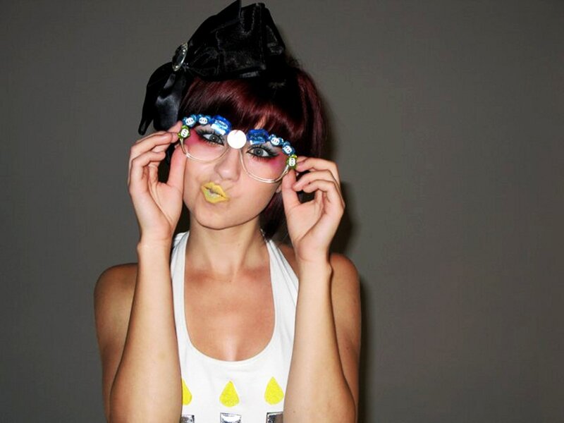 woman with glasses and colorful makeup