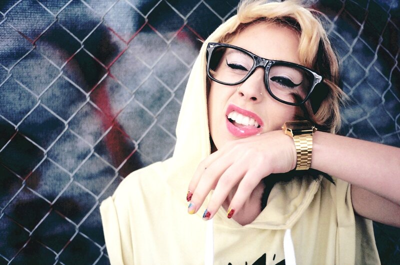 woman with glasses and colorful nails