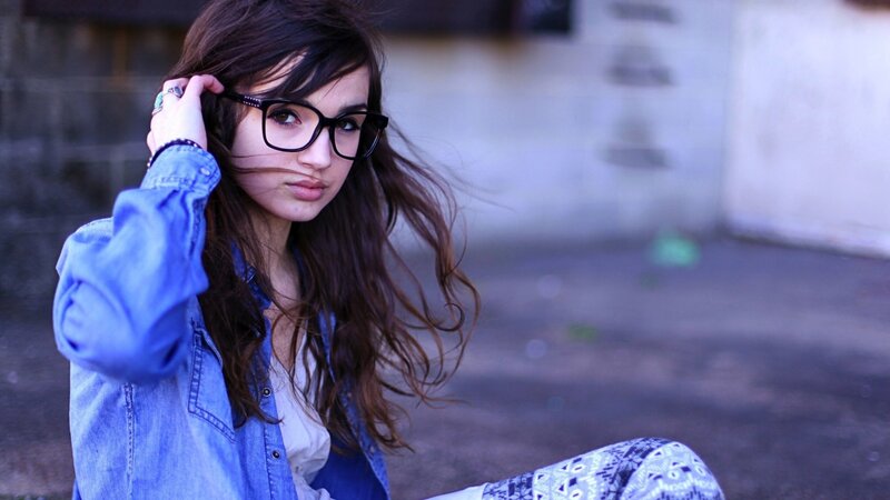 woman with glasses and denim jacket
