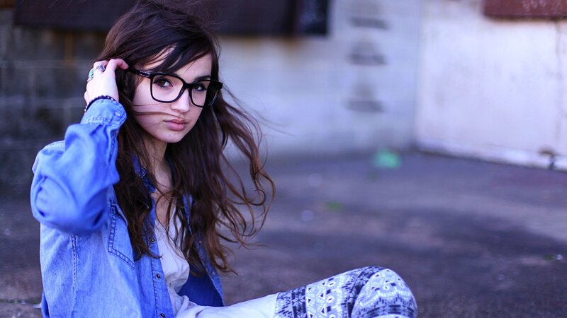 woman with glasses and denim jacket
