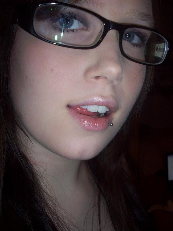 woman with glasses and lip piercing
