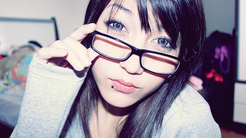 woman with glasses and lip piercing