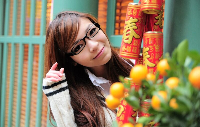 woman with glasses and mandarin oranges