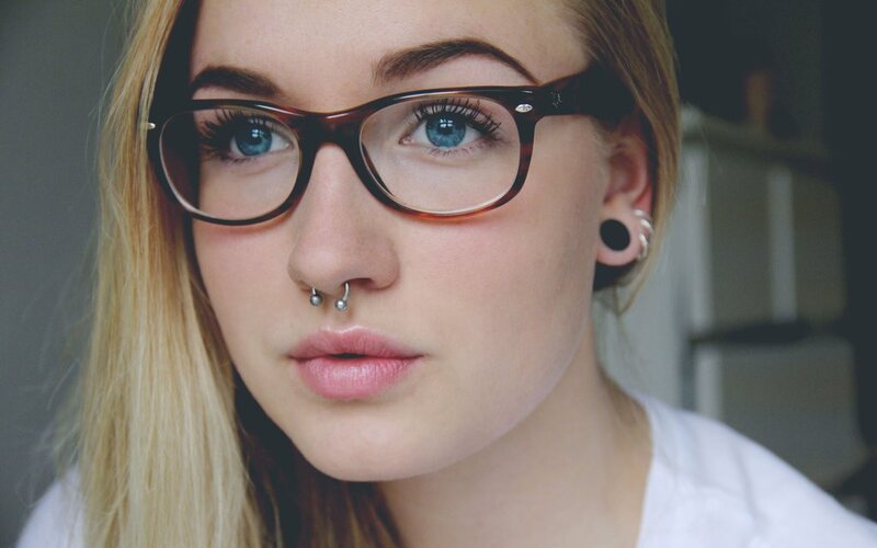 woman with glasses and nose piercing