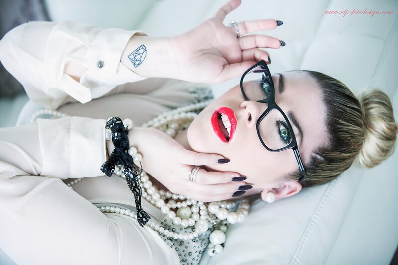 woman with glasses and pearls