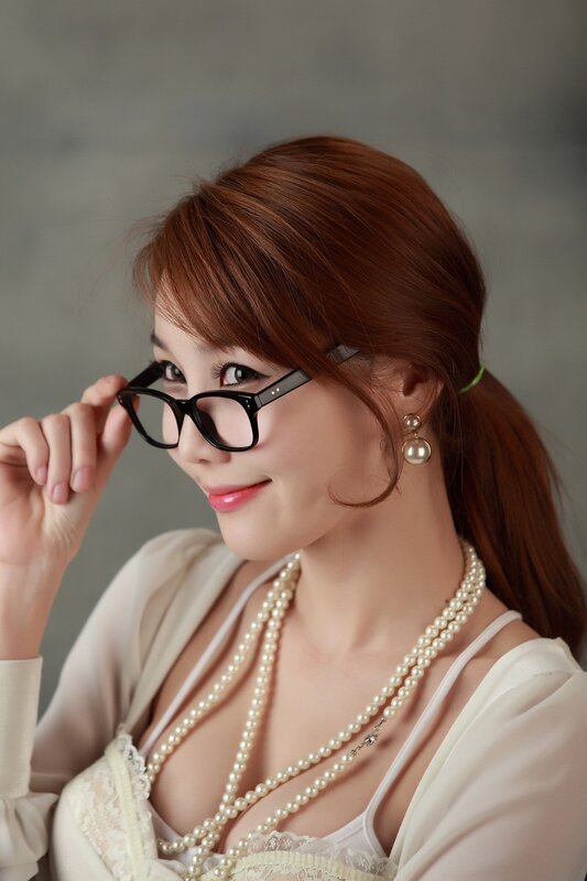 woman with glasses and pearls