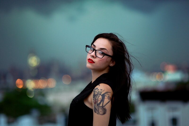 woman with glasses and tattoo