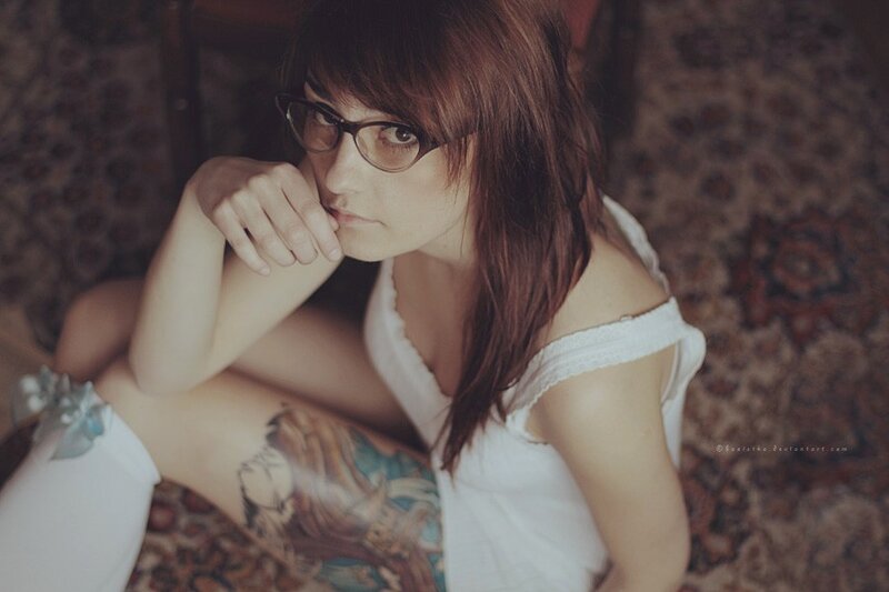 woman with glasses and tattoo