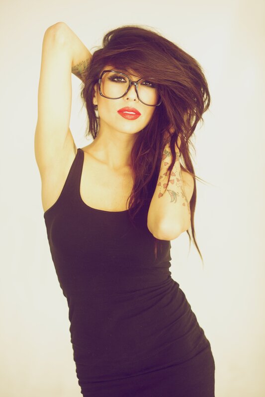 woman with glasses and tattoos