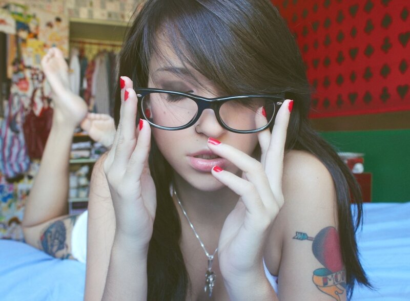 woman with glasses and tattoos