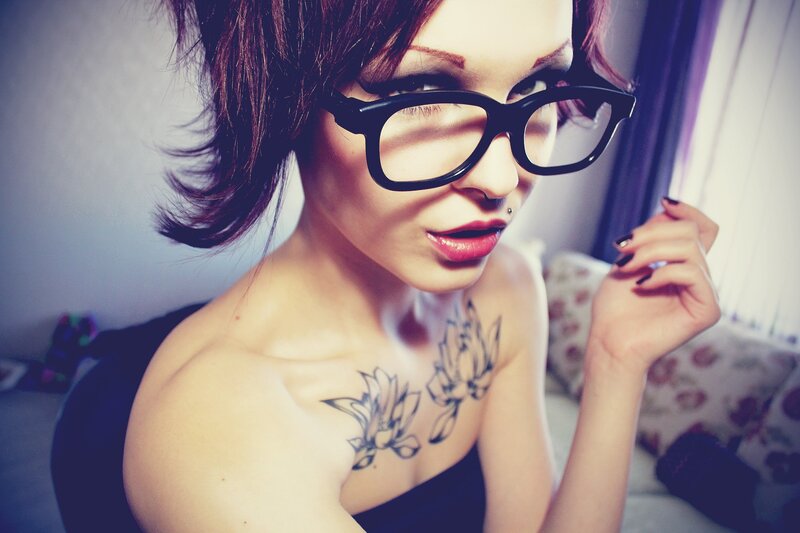 woman with glasses and tattoos
