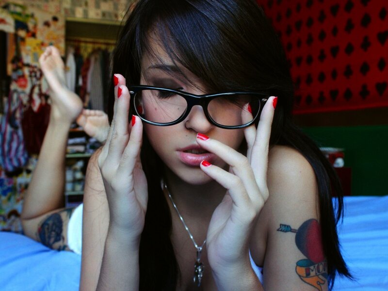 woman with glasses and tattoos