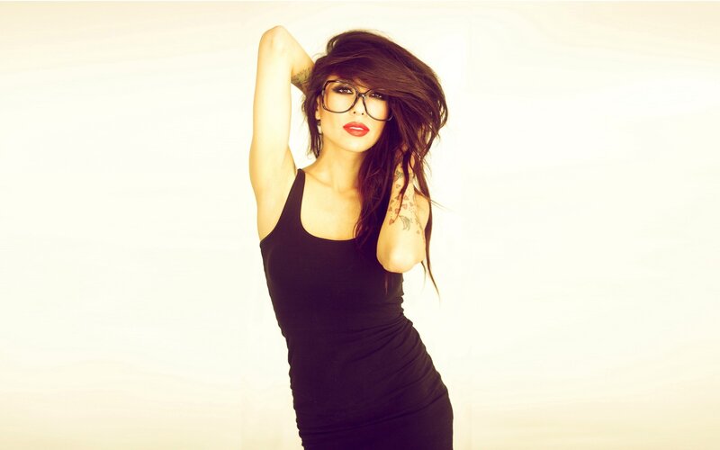 woman with glasses and tattoos