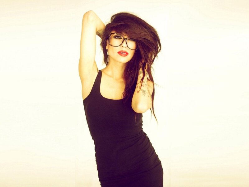 woman with glasses and tattoos