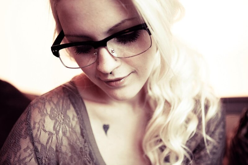 woman with glasses and tattoos
