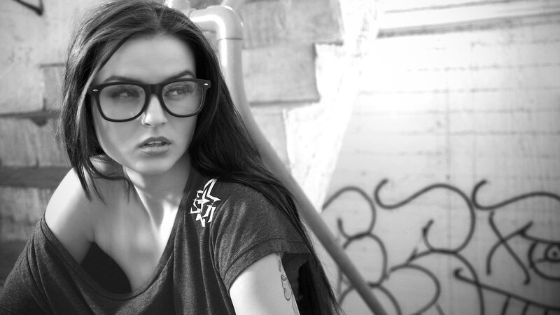 woman with glasses and tattoos