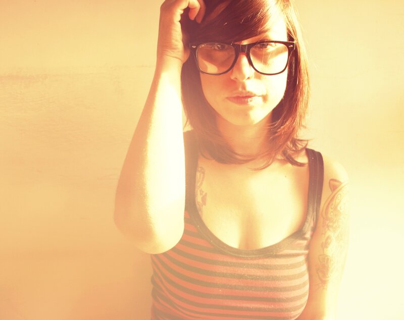 woman with glasses and tattoos
