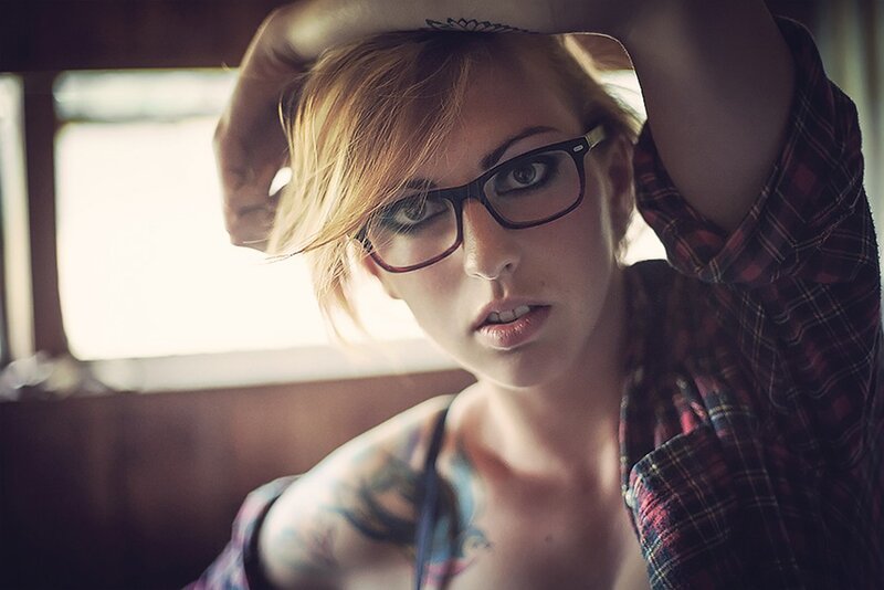 woman with glasses and tattoos