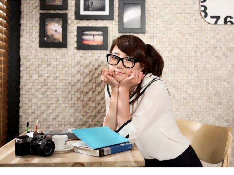 woman with glasses at a desk