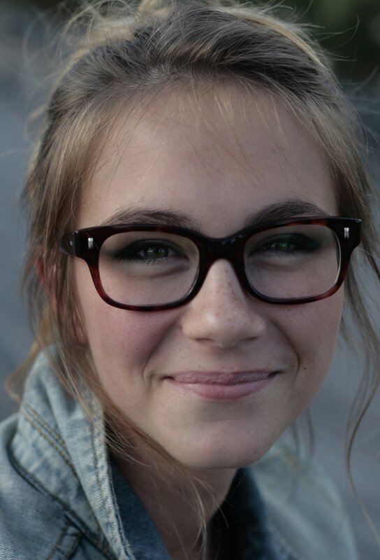 Woman with Glasses — Brown, Neutral, Photograph, Denim Jacket