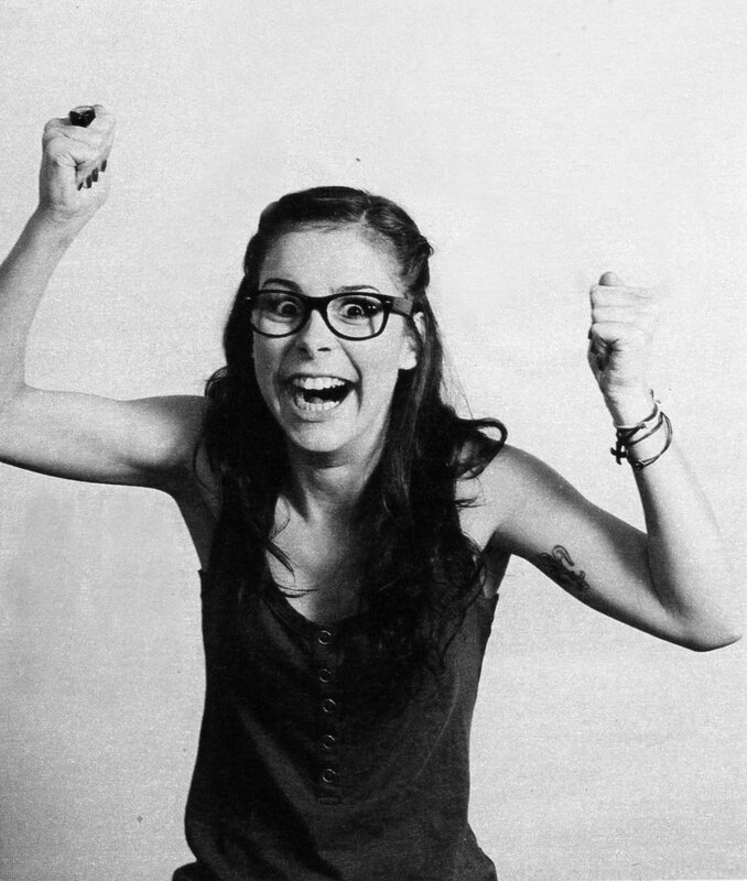 woman with glasses cheering