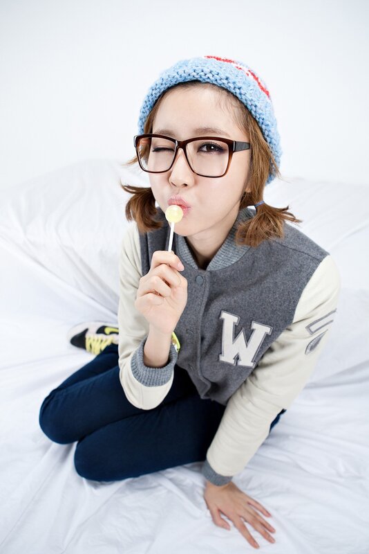 woman with glasses eating lollipop