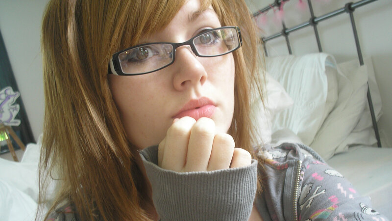 woman with glasses in bedroom
