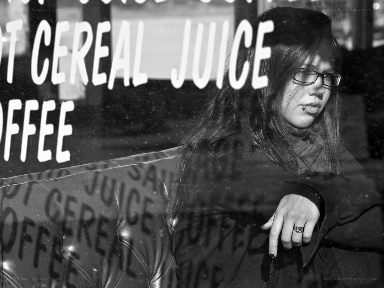 woman with glasses in cafe window