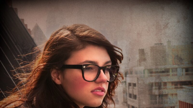 woman with glasses in city