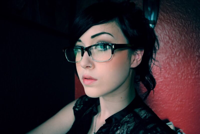 woman with glasses in dim light