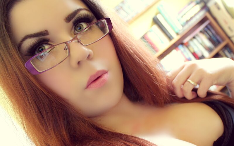 woman with glasses in library