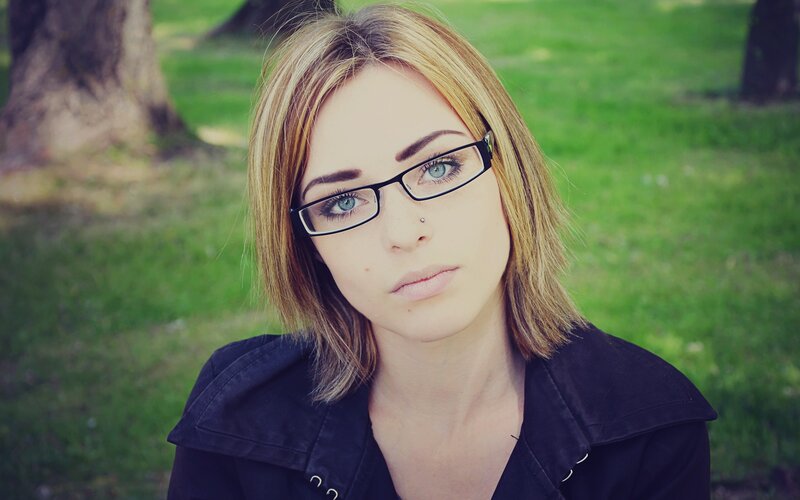 woman with glasses in park