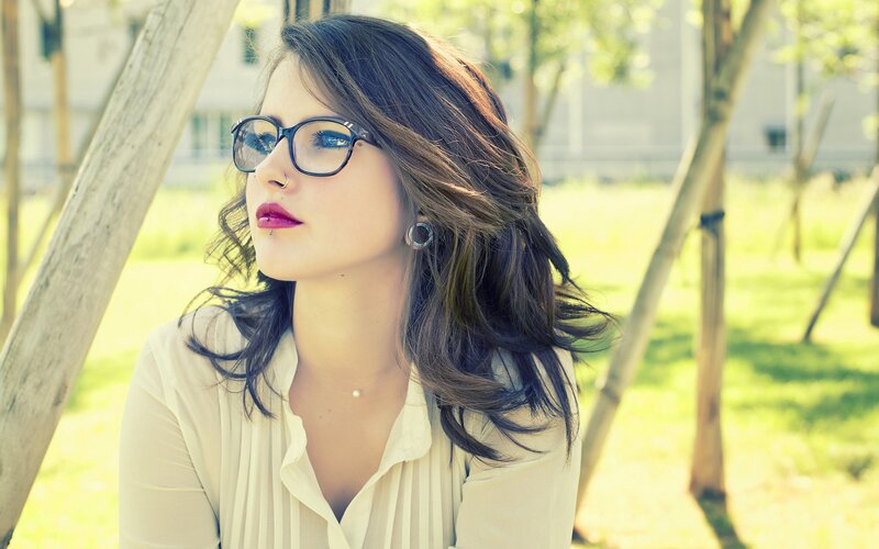 woman with glasses in park