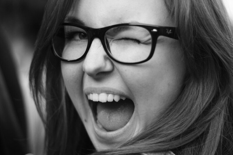 woman with glasses laughing