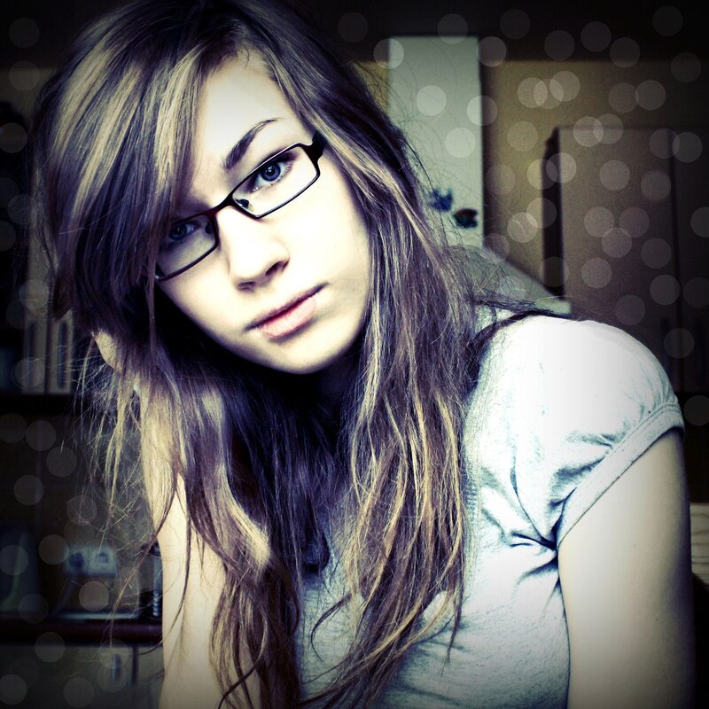 woman with glasses looking at camera
