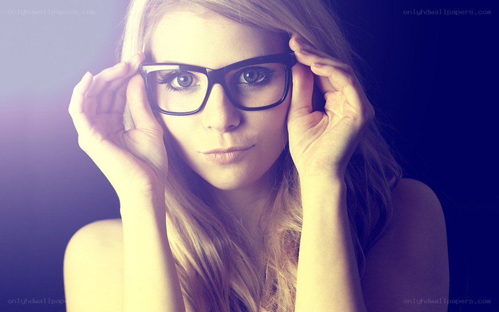 woman with glasses looking at camera