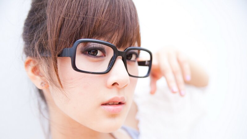 woman with glasses looking at camera