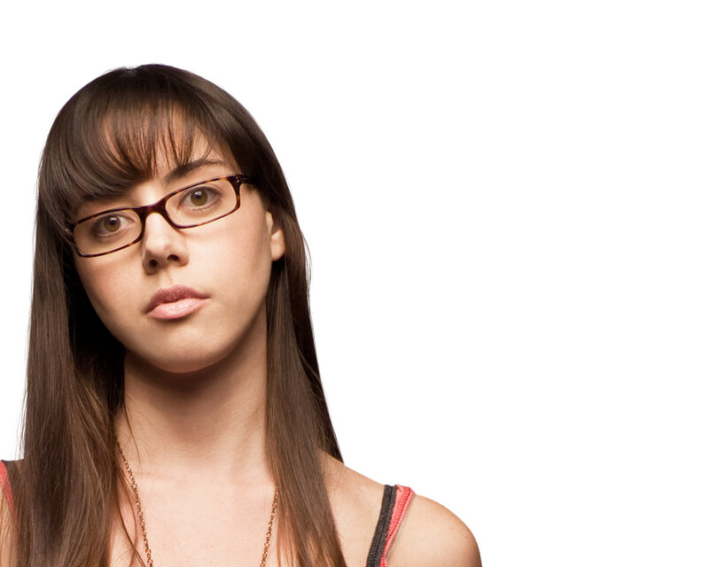 woman with glasses looking at camera