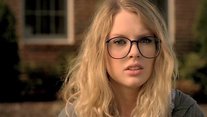 woman with glasses looking at camera