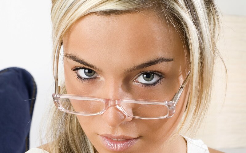woman with glasses looking at camera