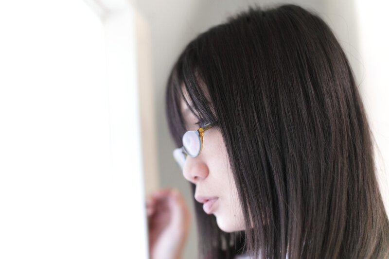 woman with glasses looking at screen