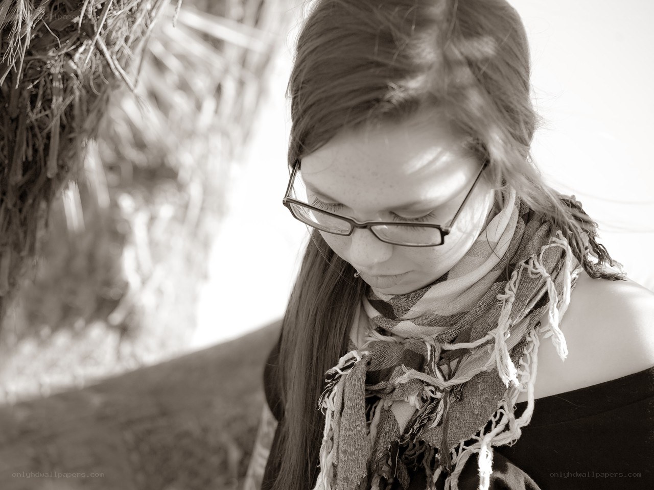 woman with glasses looking down