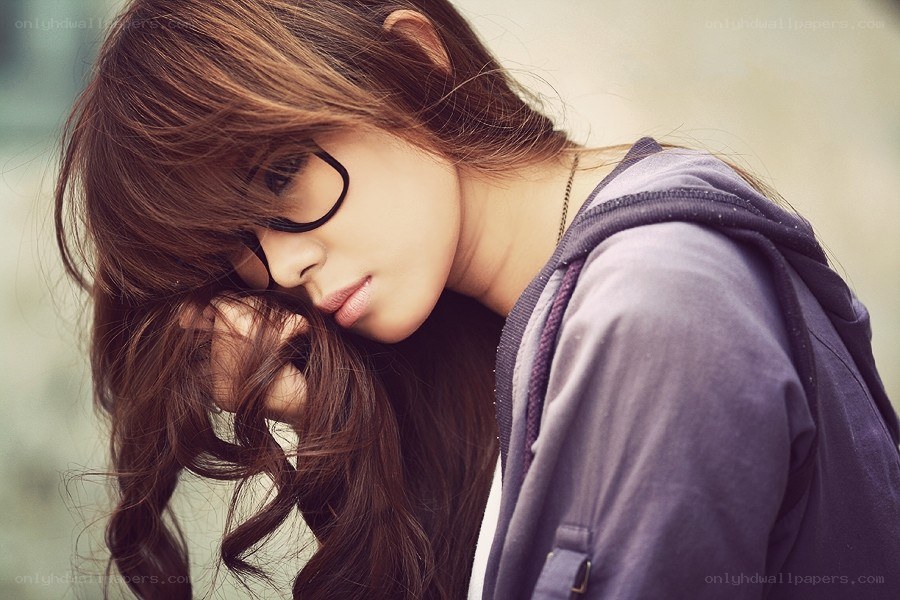 woman with glasses looking down